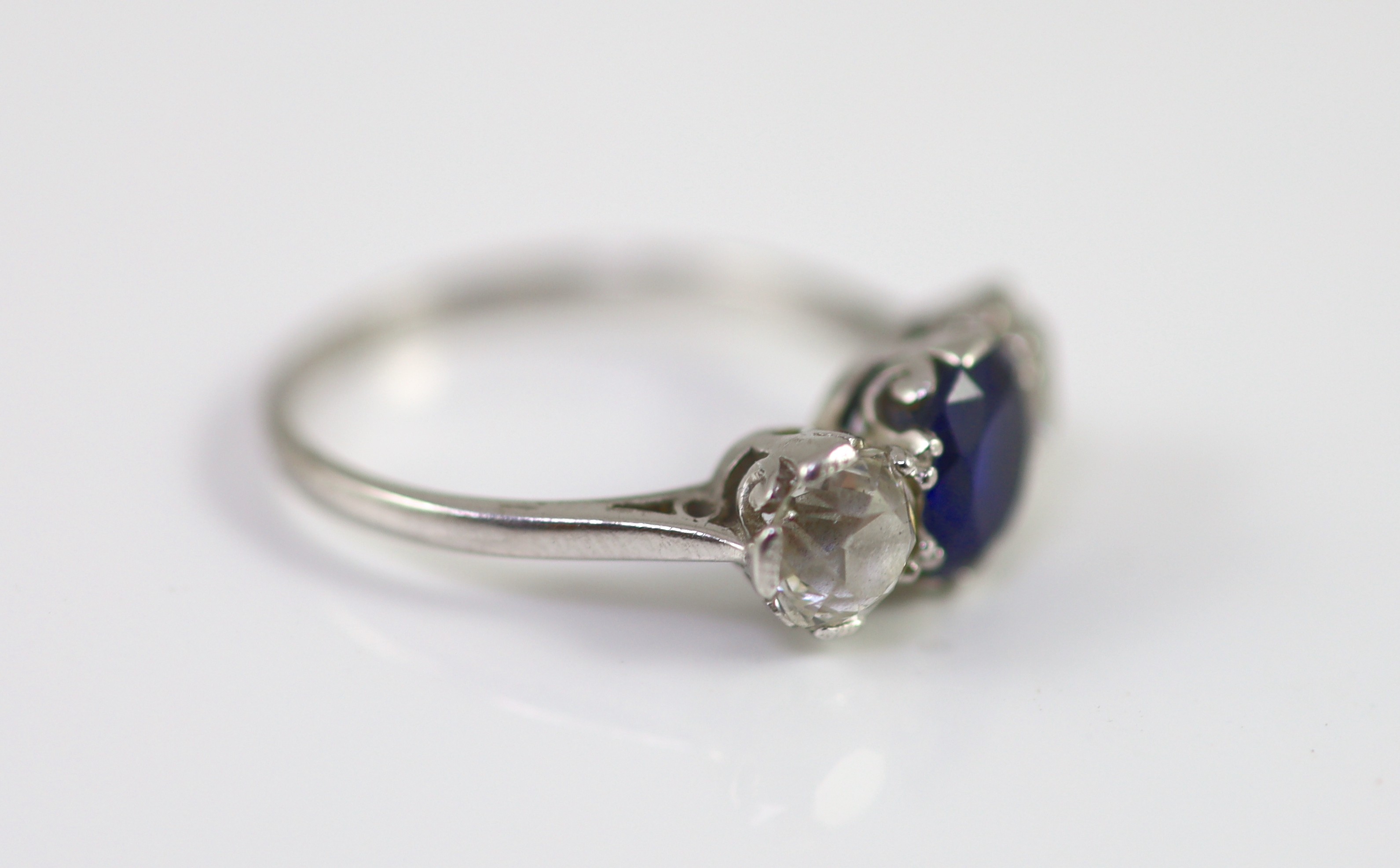 A platinum two stone diamond and single stone sapphire ring